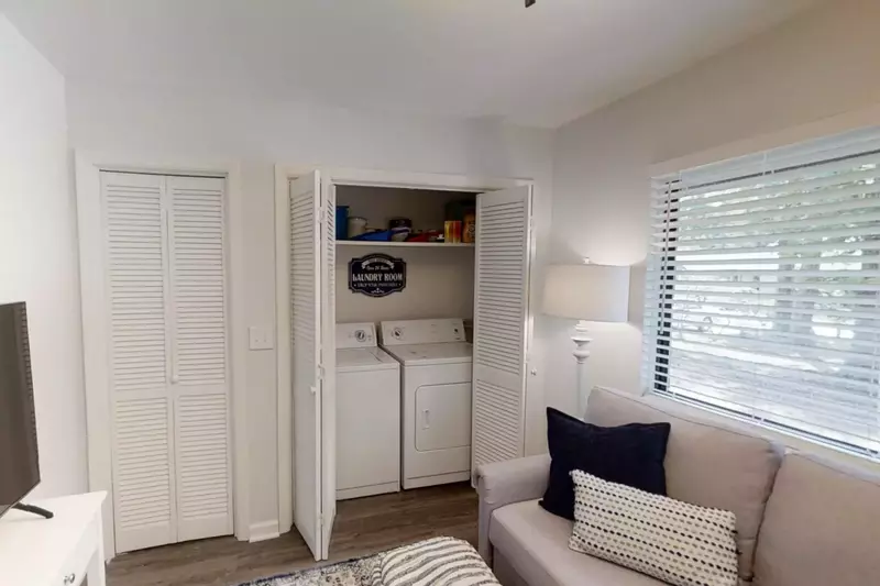The washing machine and dryer are tucked away in a closet in the den.