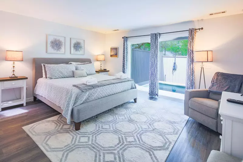 The master suite features a king bed and night stands with reading lamps.