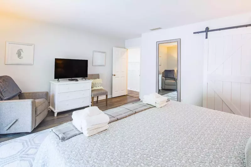 There is also a dresser, flat screen TV and full-lengthed mirror in the master suite.