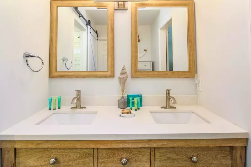 The en suite bathroom features a dual sink vanity.