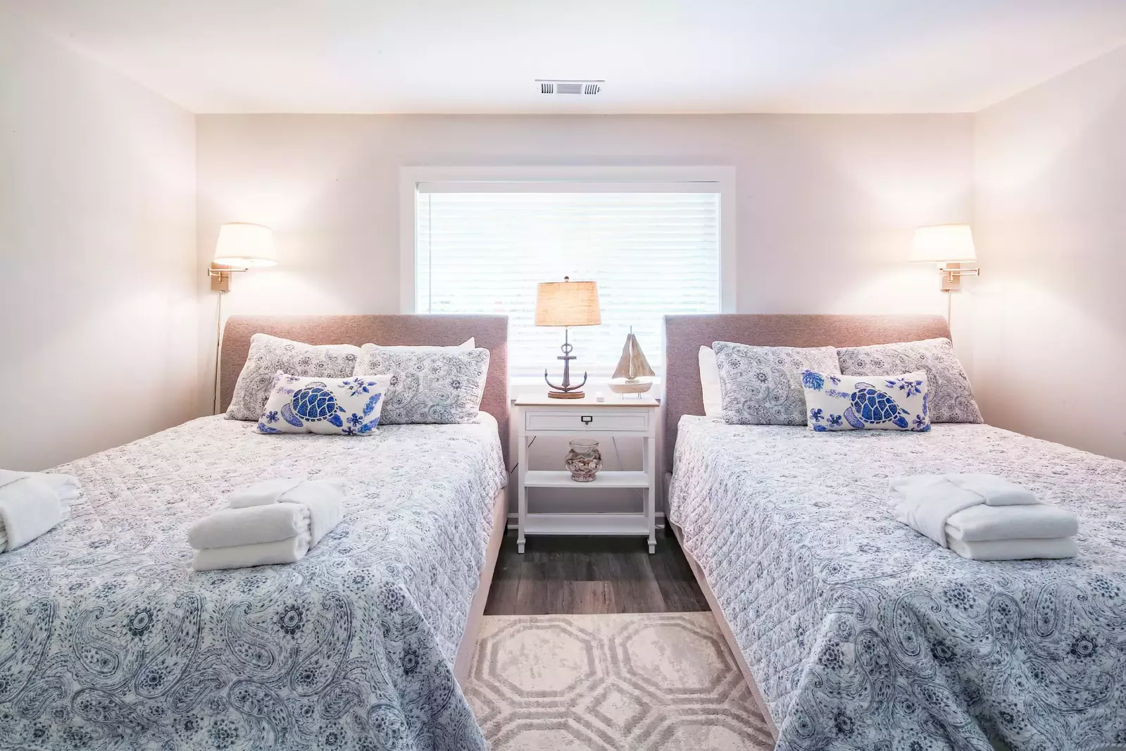 The queen guest bedroom also has a night stand, reading lamp and two wall sconces.