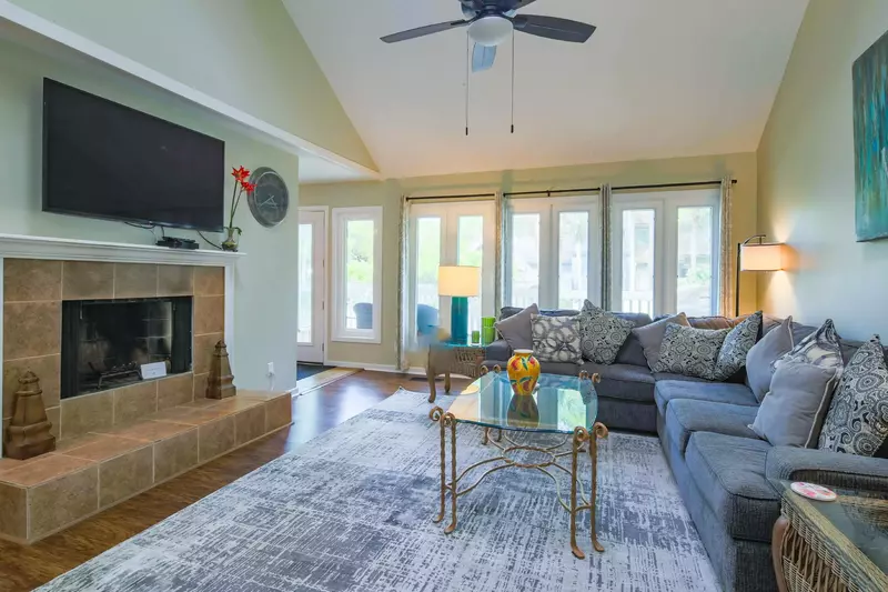 The living room also has a wall-mounted TV, ceiling fan and views of the back deck.  (Fireplace not available.)