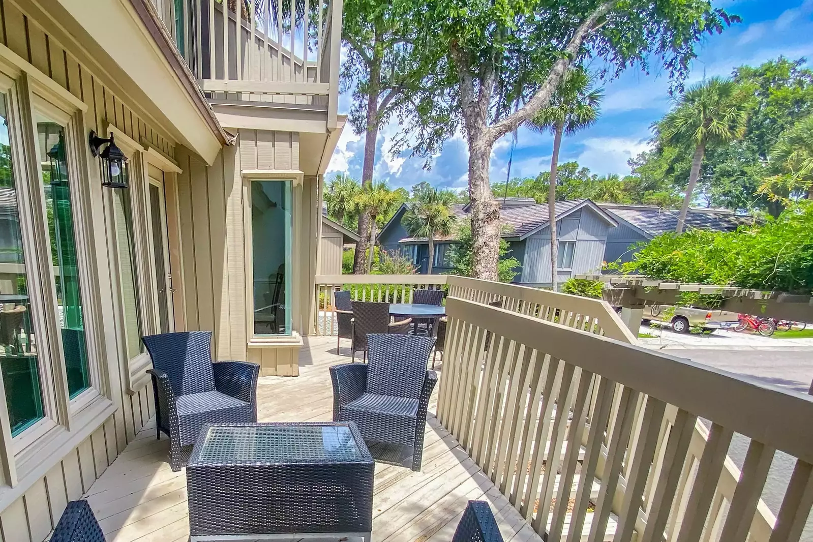 Step out onto the back deck to find this seating area, dining table and lovely Lowcountry sunshine.