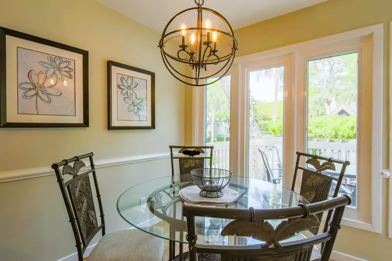This dining table in between the kitchen and back porch seats 4.