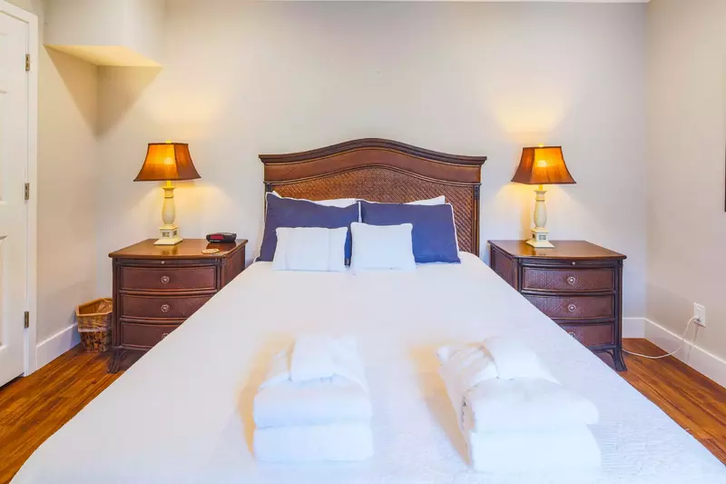 The queen suite features a queen bed and night stands with reading lamps.