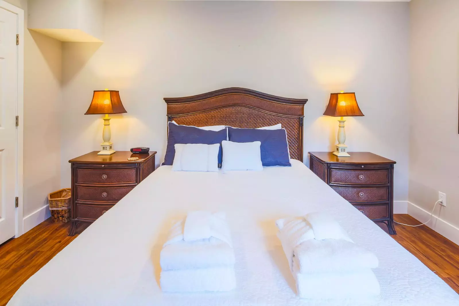 The queen suite features a queen bed and night stands with reading lamps.