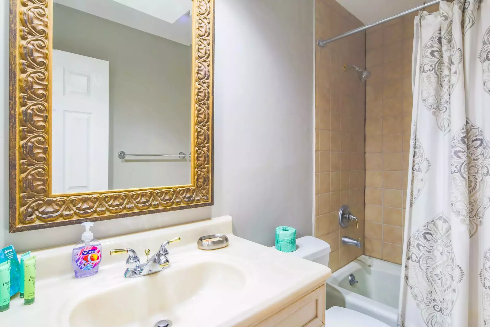 The en suite bathroom for the queen suite features a spacious vanity and shower/tub combo.