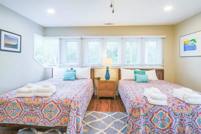 This guest bedroom with wonderful natural light is located on the middle level of the home.