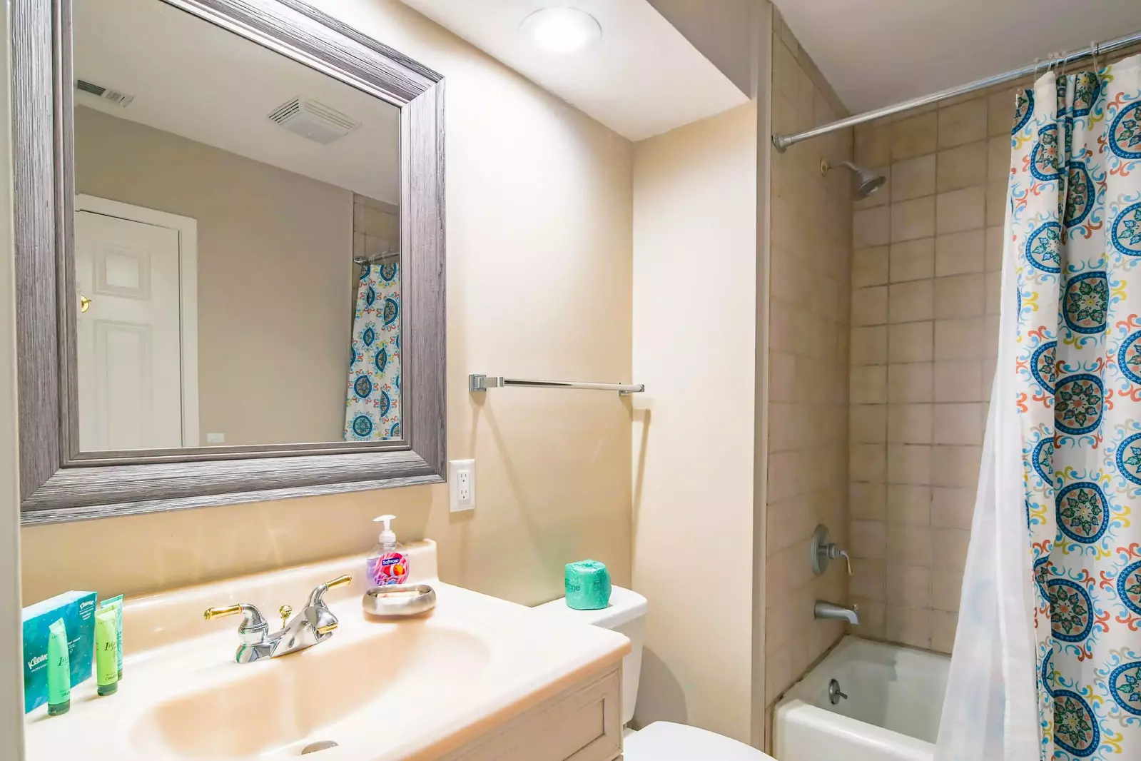 The guest bedroom has shared access to this hall bathroom with a vanity and shower/tub combo.