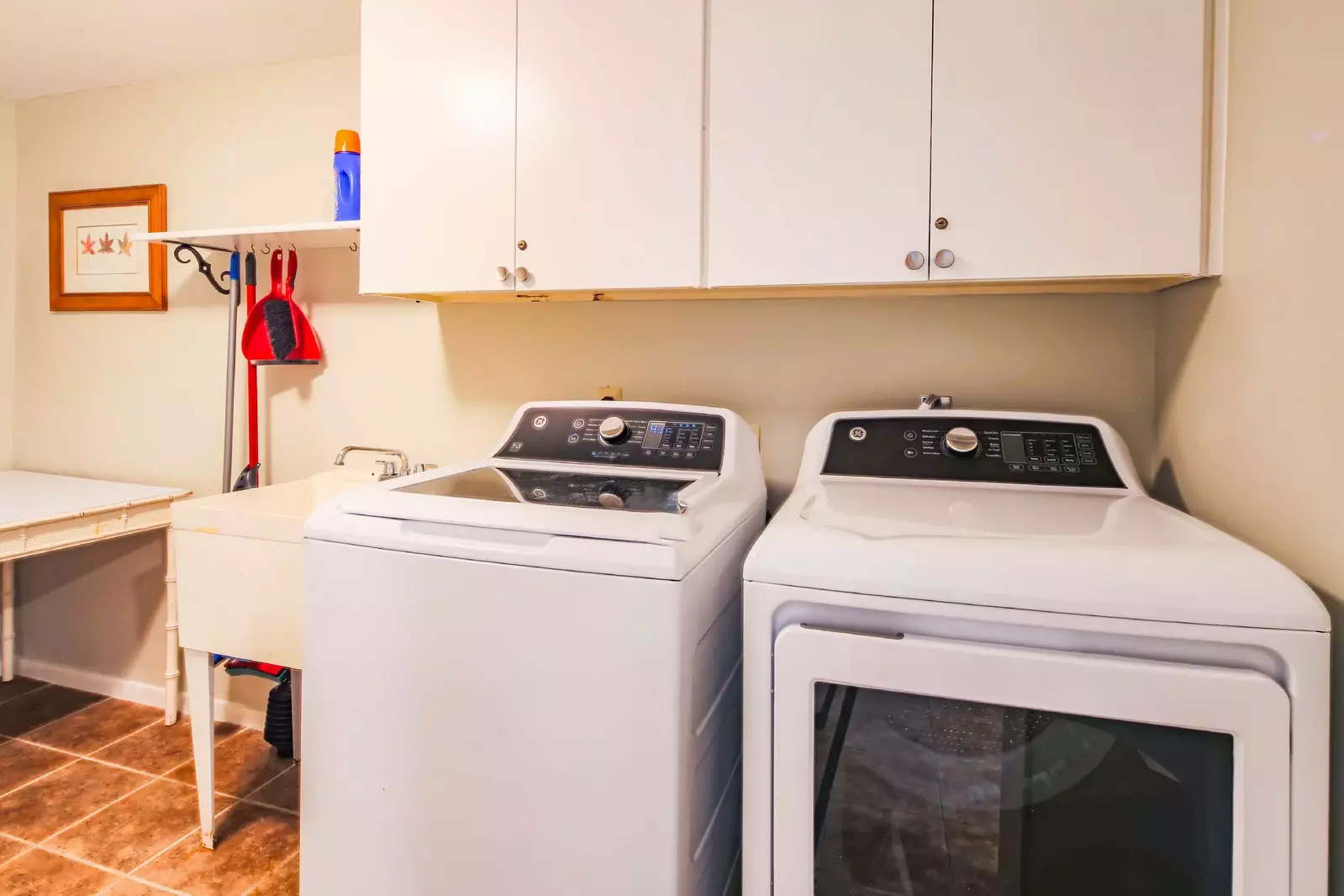There is a laundry room near the kitchen with full-sized washing machine and dryer in the home.
