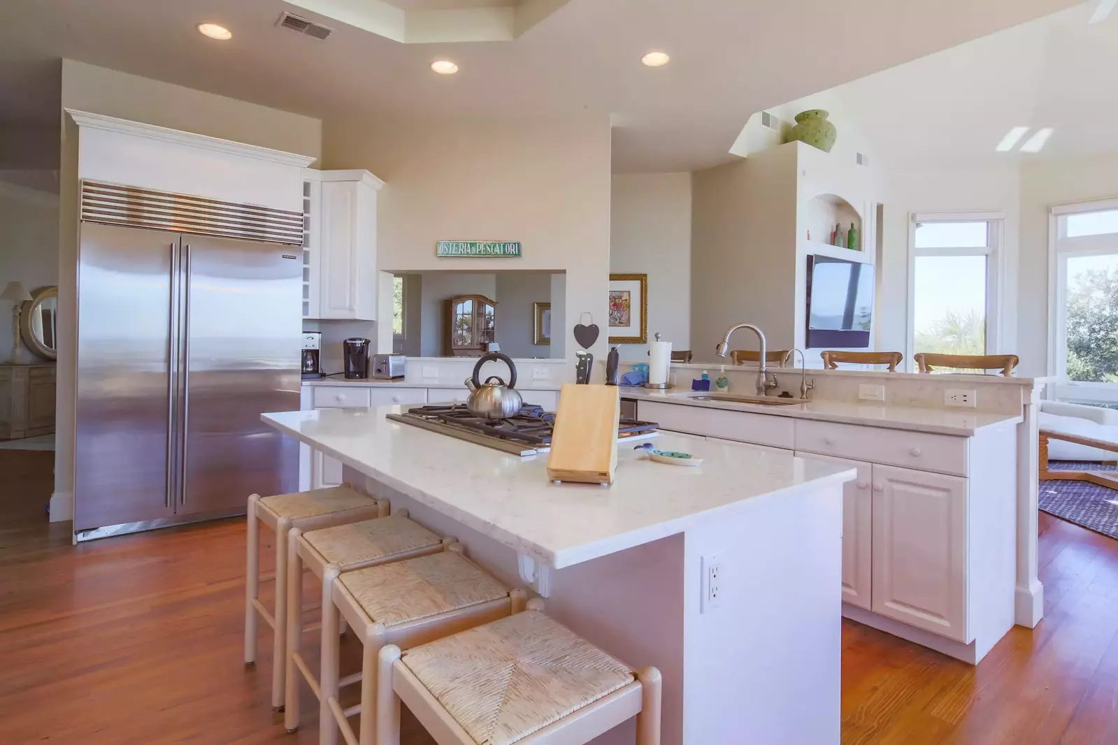 The kitchen features white cabinetry, high end appliances and a central island.