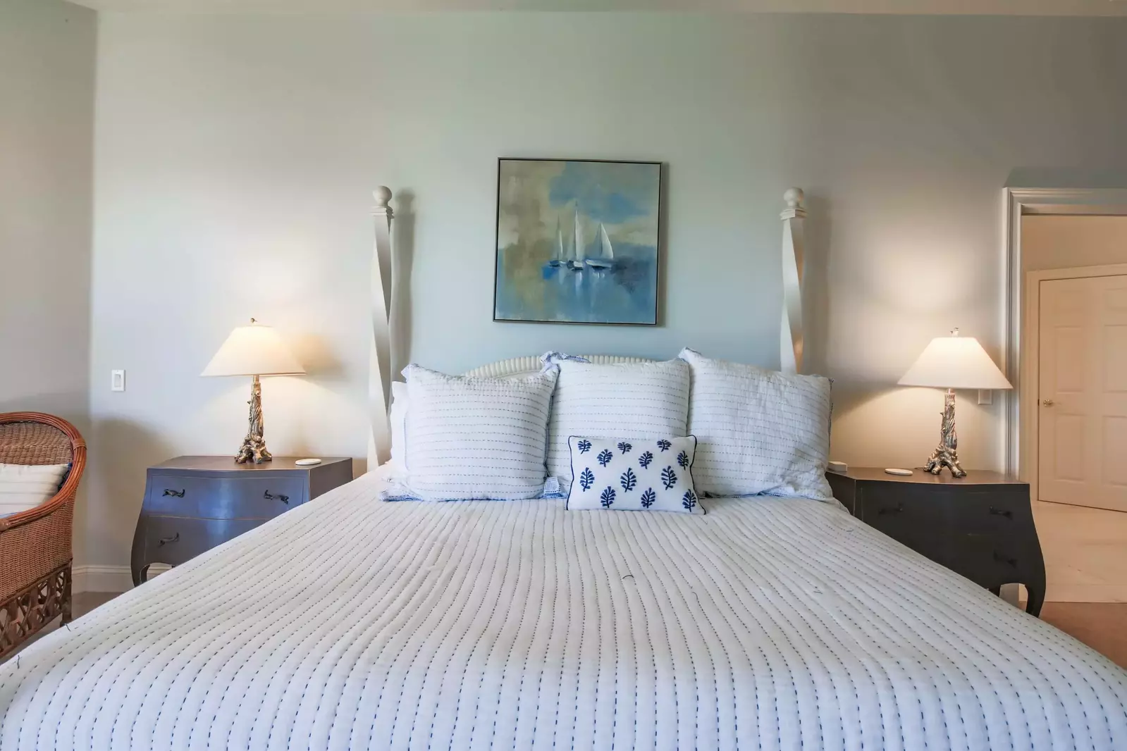 The master suite also has night stands with reading lamps, a seating area and an en suite bathroom.