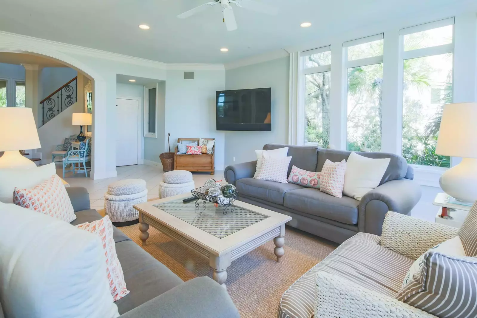 This lower level family room features a spacious seating area and wall-mounted TV.