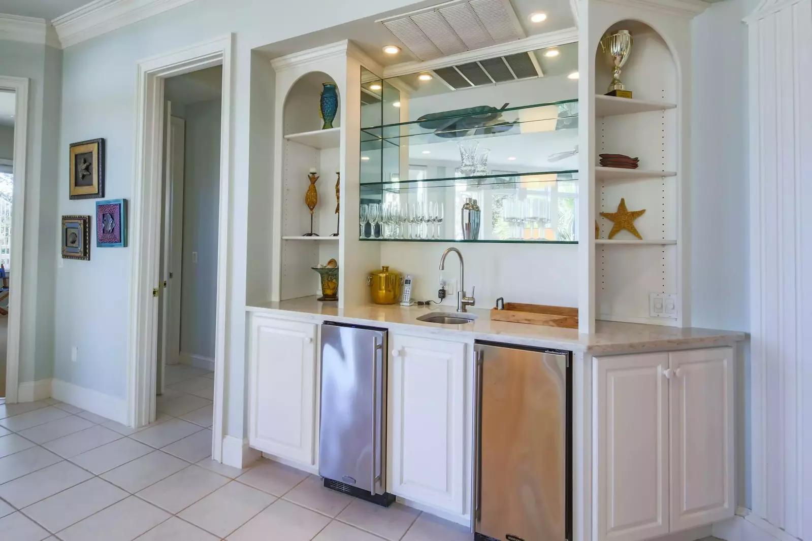 This wet bar with an ice machine and small refrigerator is located off of the lower level family room.