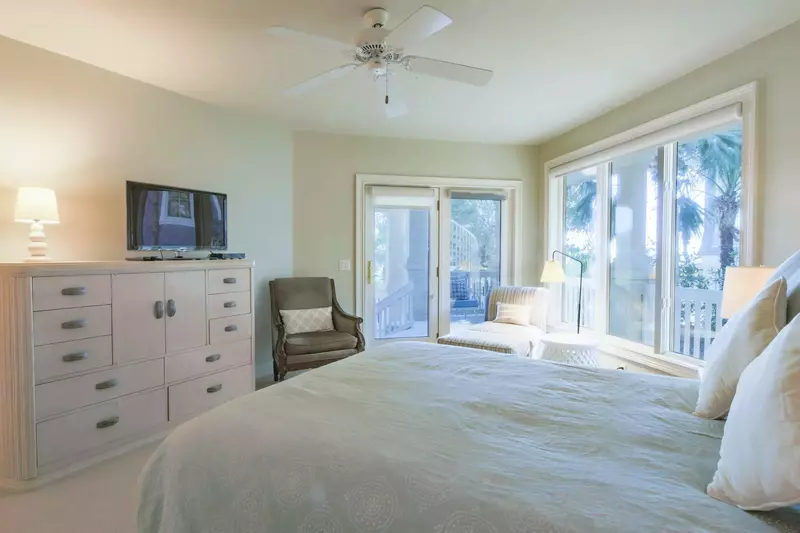 This guest suite also feature access to the back porch, a seating area and TV.