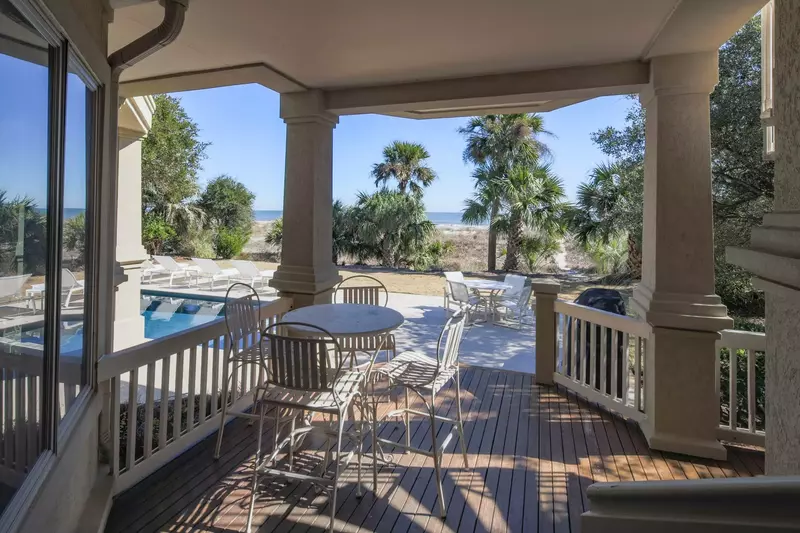 Walk out of the guest suite to find this covered porch and pool area.