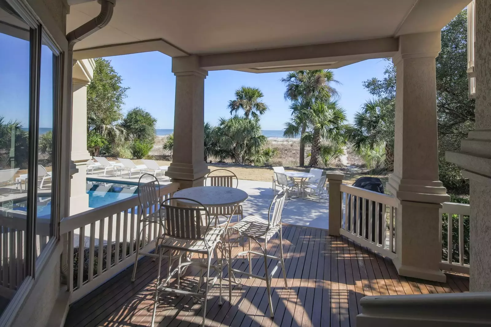 Walk out of the guest suite to find this covered porch and pool area.