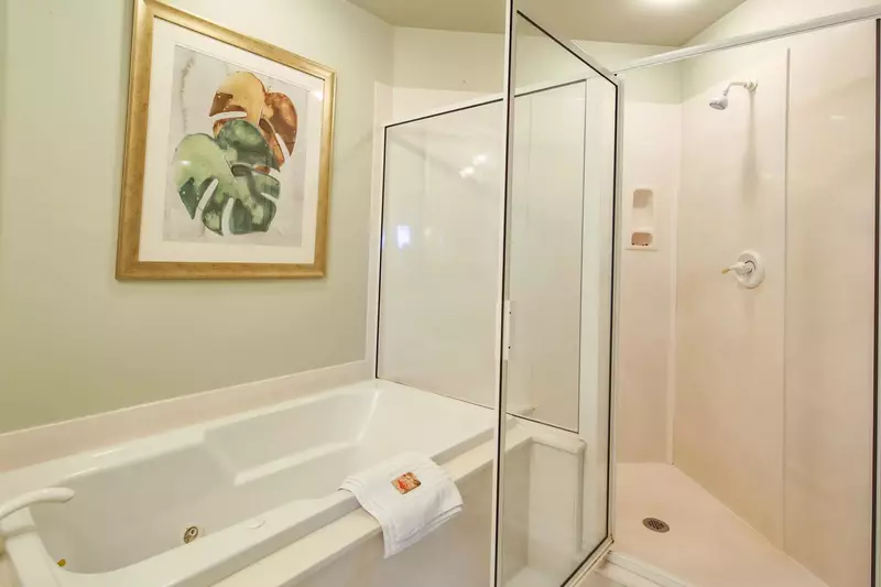 This en suite bathroom also has a soaking tub and walk-in shower.