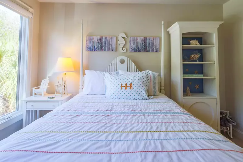 This guest suite features a queen bed and night stand with reading lamp.