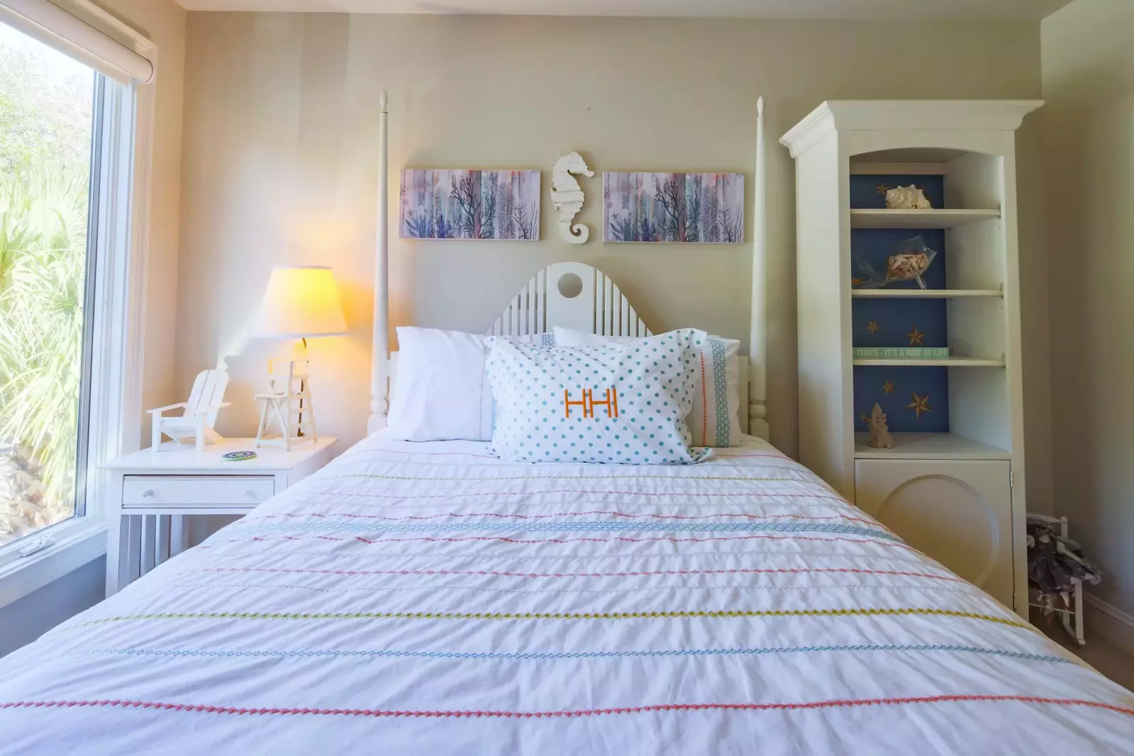 This guest suite features a queen bed and night stand with reading lamp.