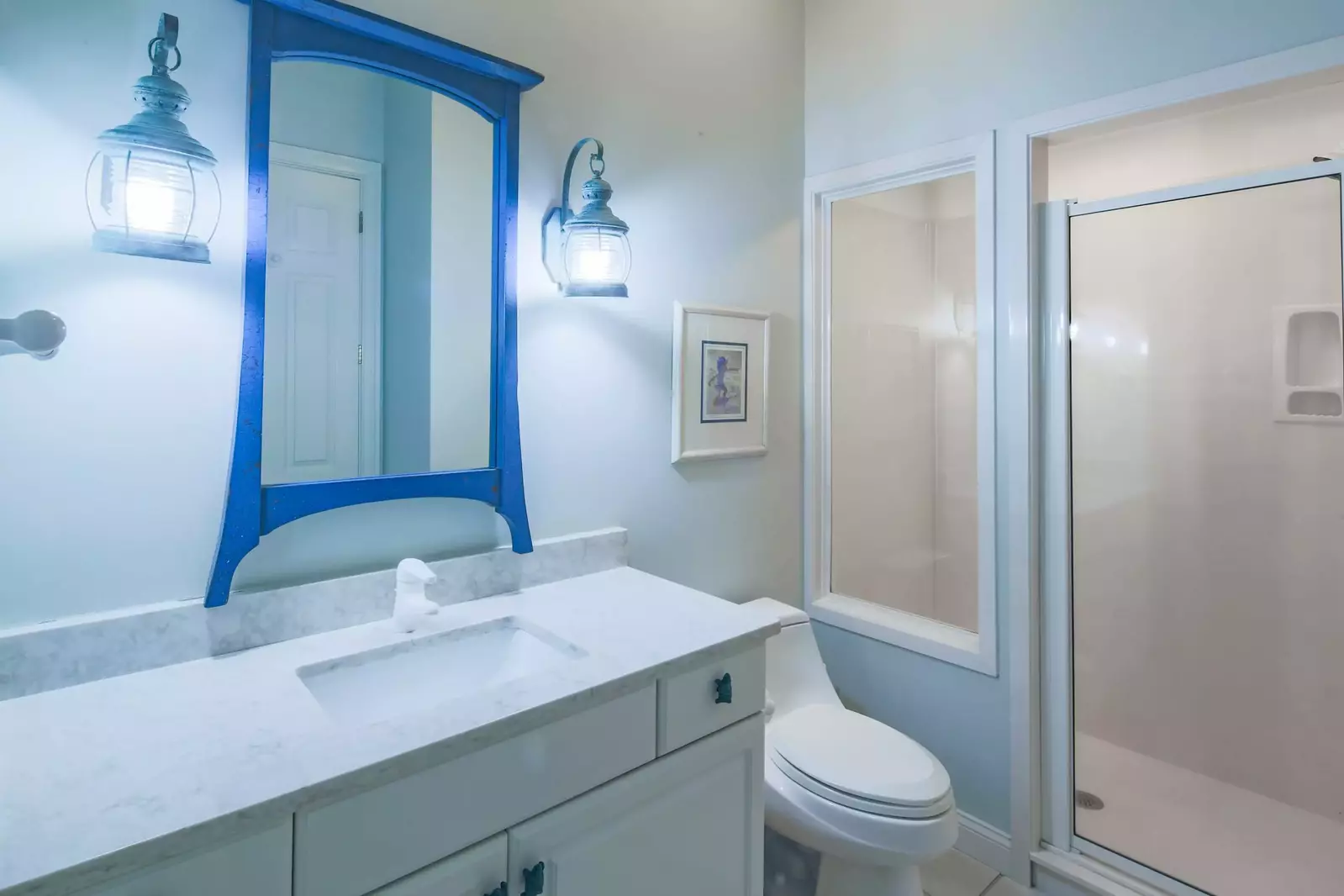 This bathroom with vanity and walk-in shower is accessible from the guest bedroom and family room.