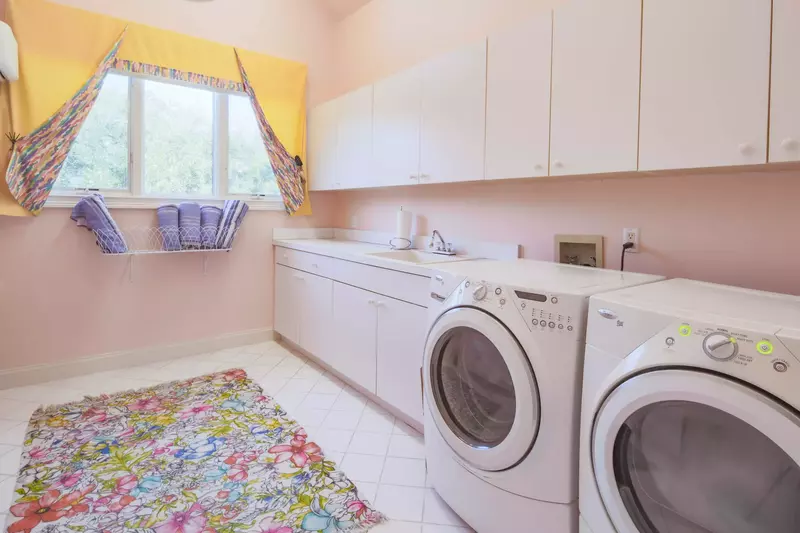 There is a laundry room with a full sized washing machine and dryer in the home.