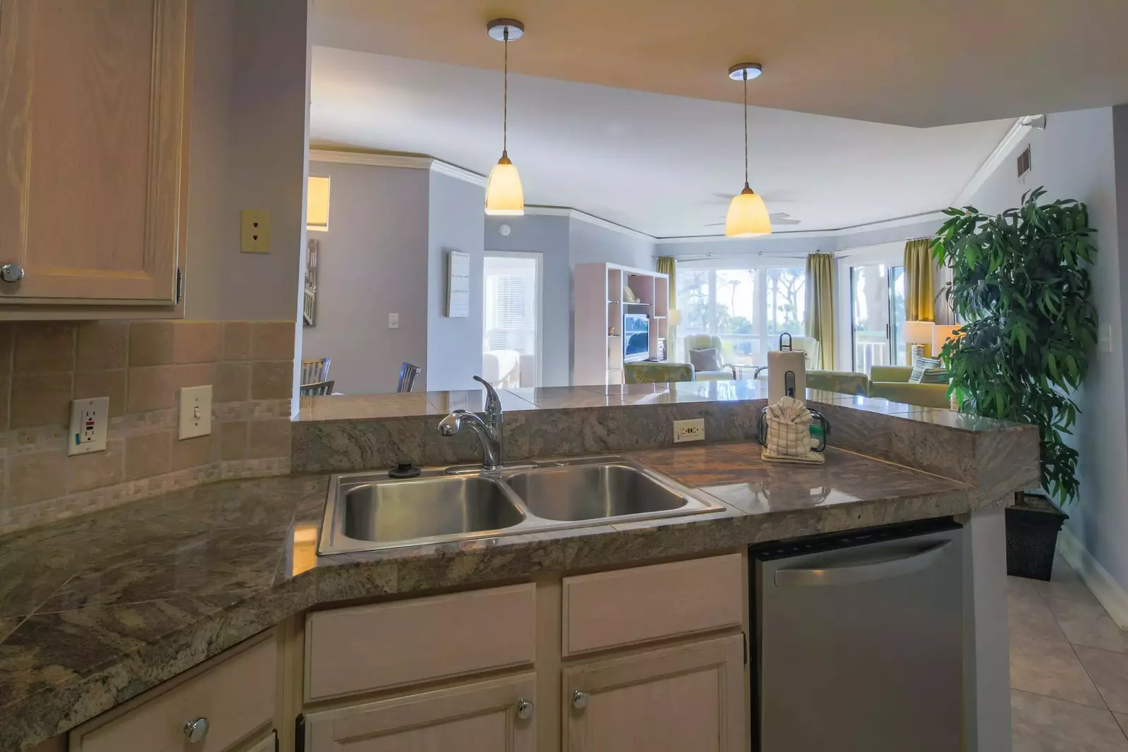 The open floor plan layout between the living room, kitchen and dining area creates stunning views of the ocean.