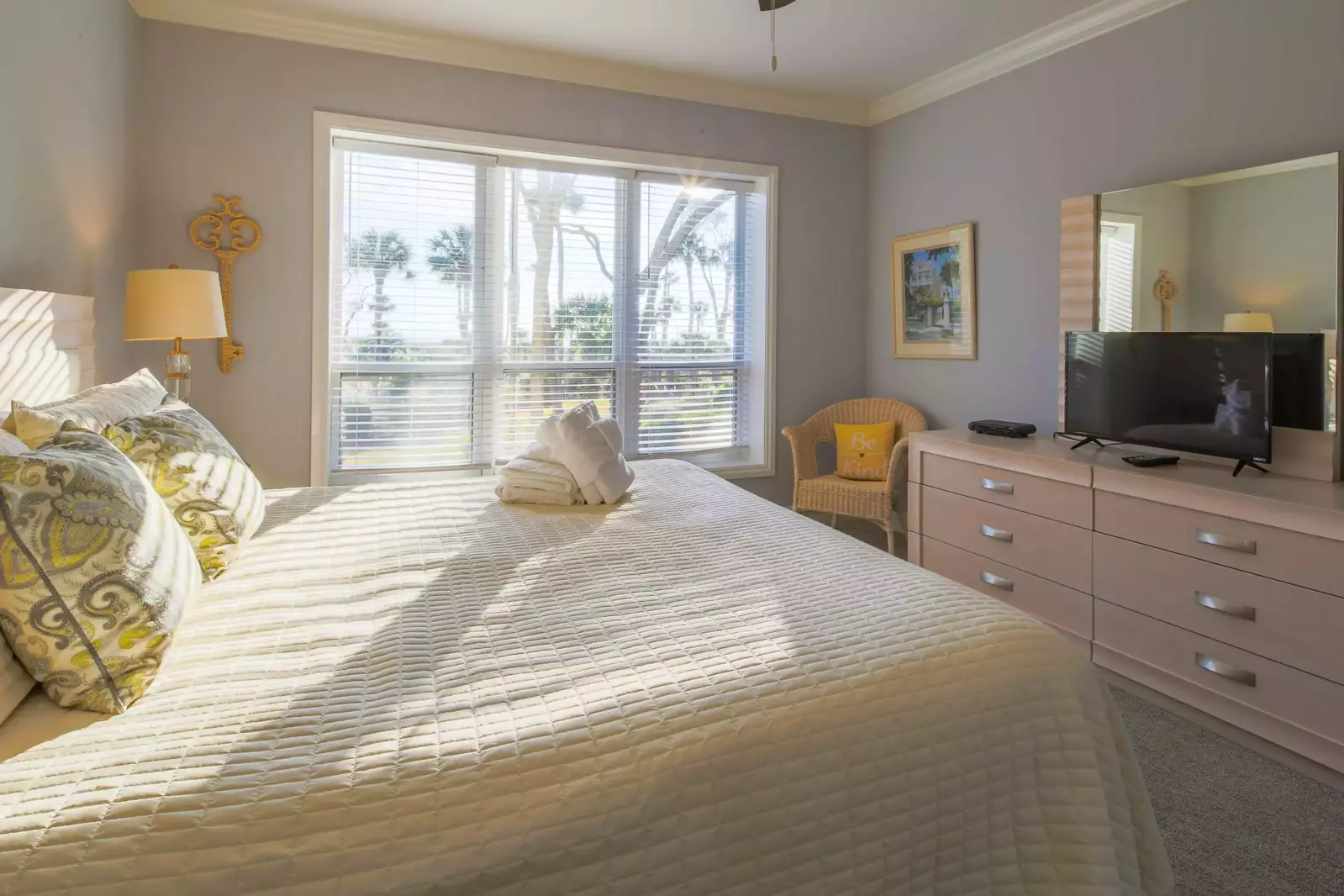The master suite also has a dresser, chair and flat screen TV.