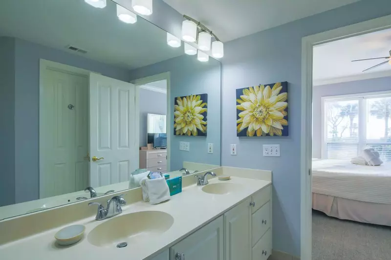 The en suite bathroom for the master suite features a spacious, double sink vanity.