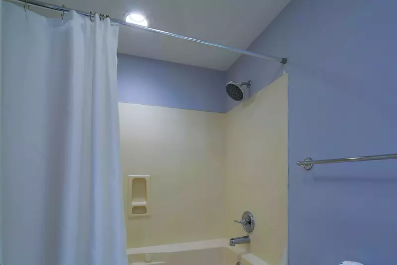 The en suite bathroom for the guest suite also has a shower/tub combo.