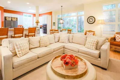 There is an open floor plan layout between the den, kitchen dining area and kitchen.