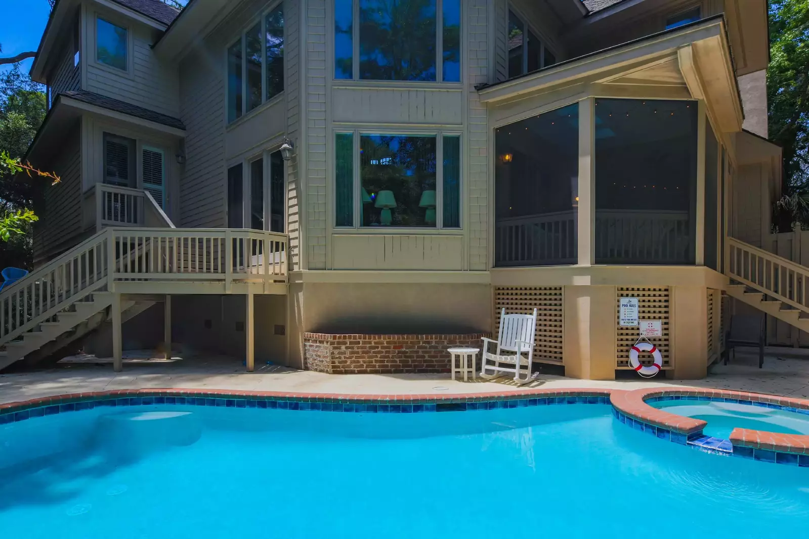 There are steps to the pool area from the screened porch and the master suite & living room.