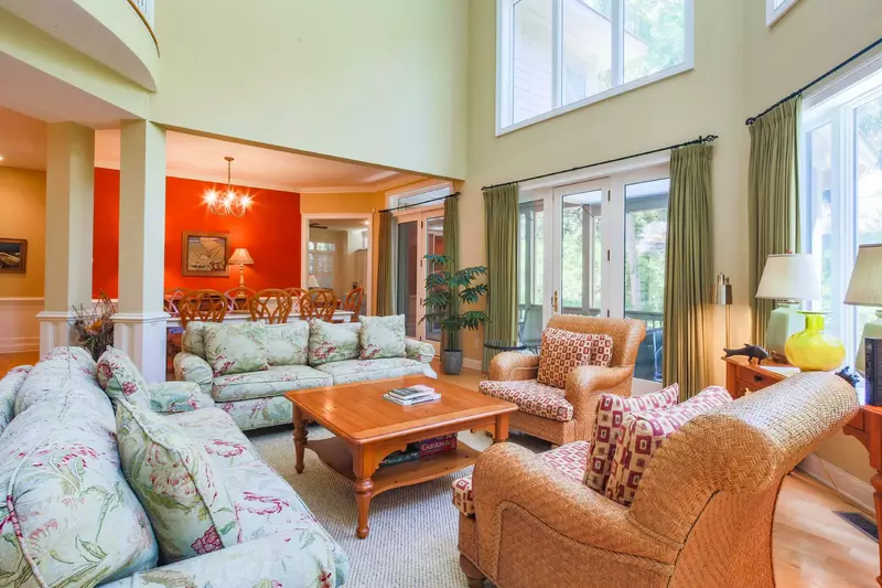 The living room opens into the dining room and screened porch.