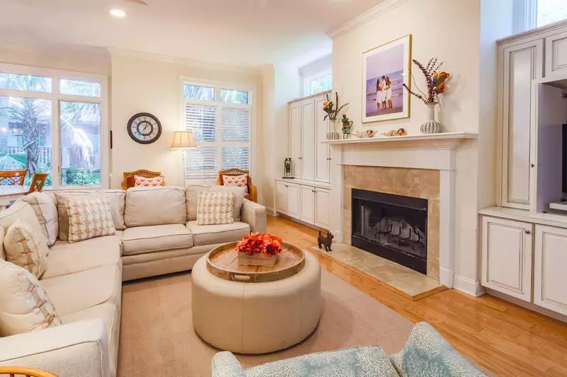 The den has a large sectional sofa and a TV.