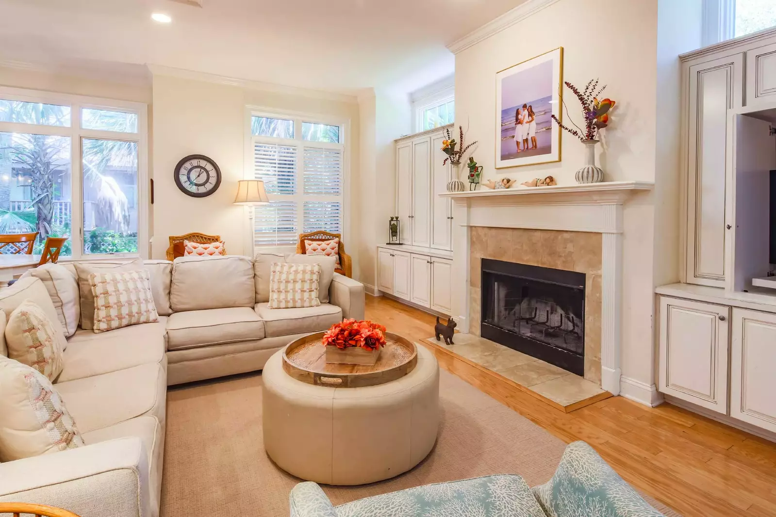 The den has a large sectional sofa and a TV.