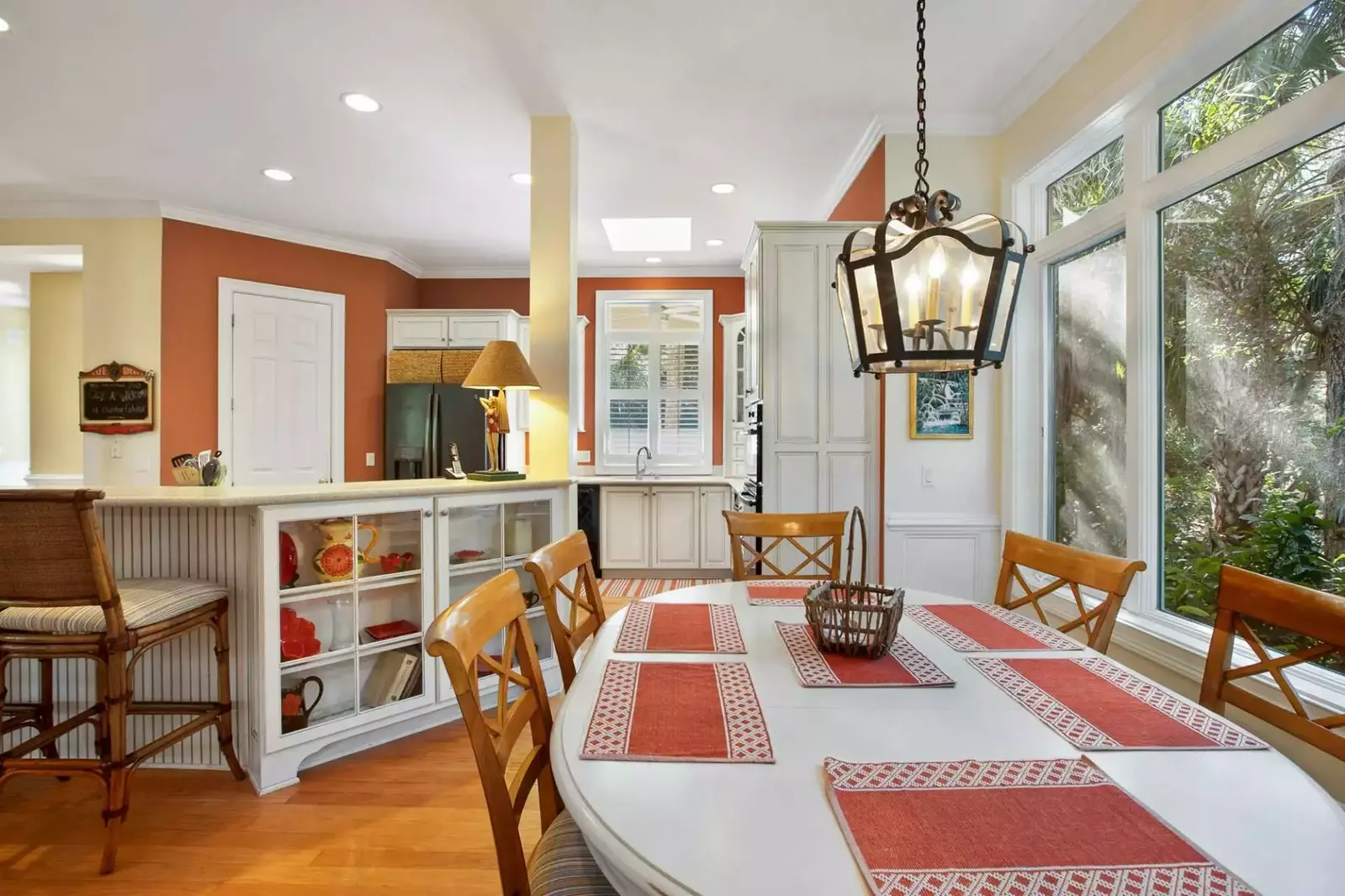 The kitchen table is situated between the den and the kitchen.