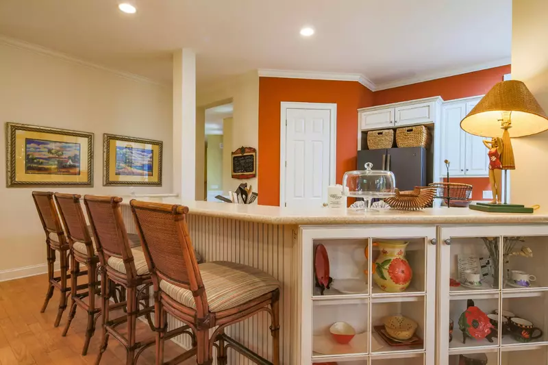 There are four high top stools at the kitchen counter.