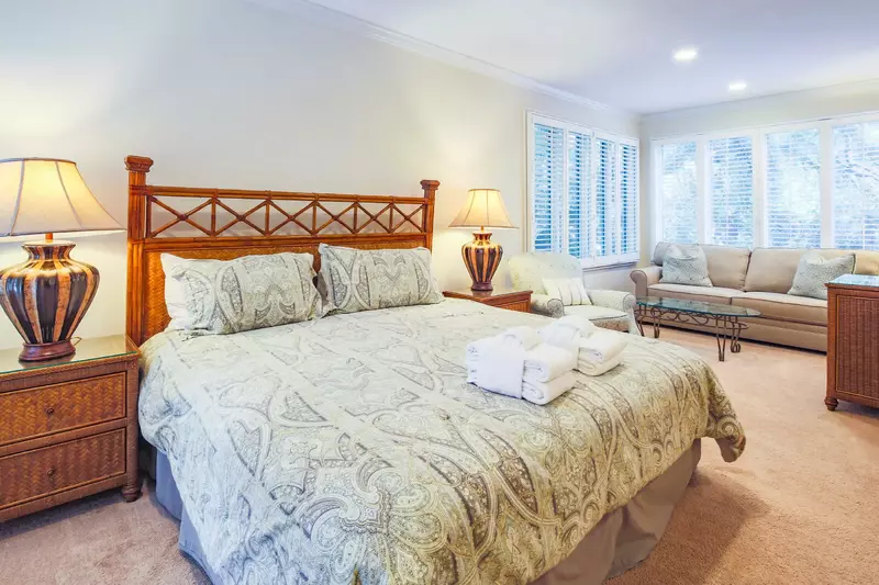 The master suite features a spacious sitting area with lovely natural light.