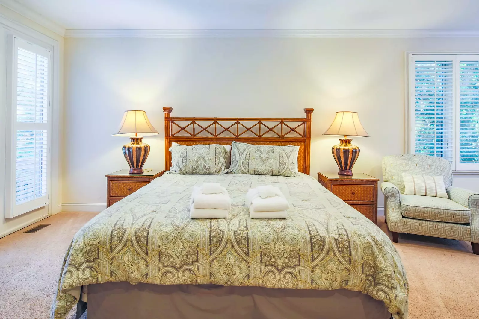 The master suite features a king bed and night stands with reading lamps.