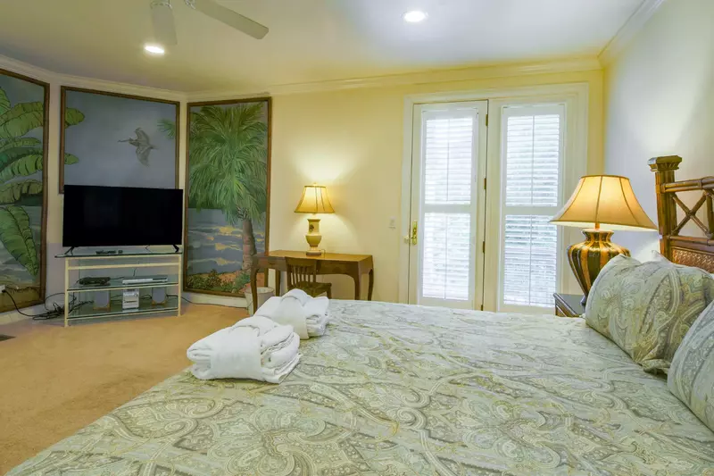 The master suite also features a large screen TV, access to the back deck and a desk.