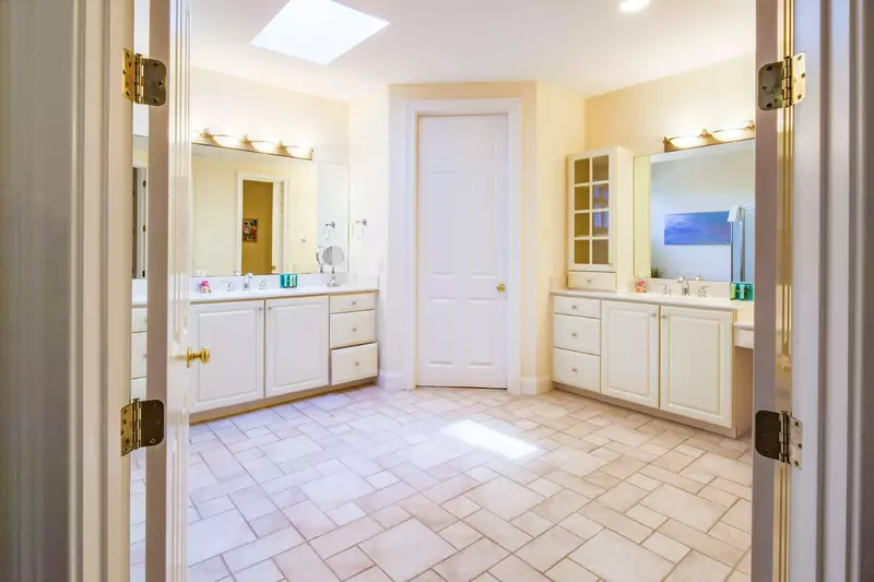The large en suite bathroom has two separate vanities.
