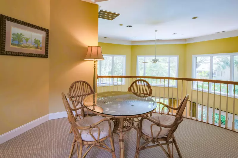 There is also a game table in the family room near the balcony that overlooks the living room.