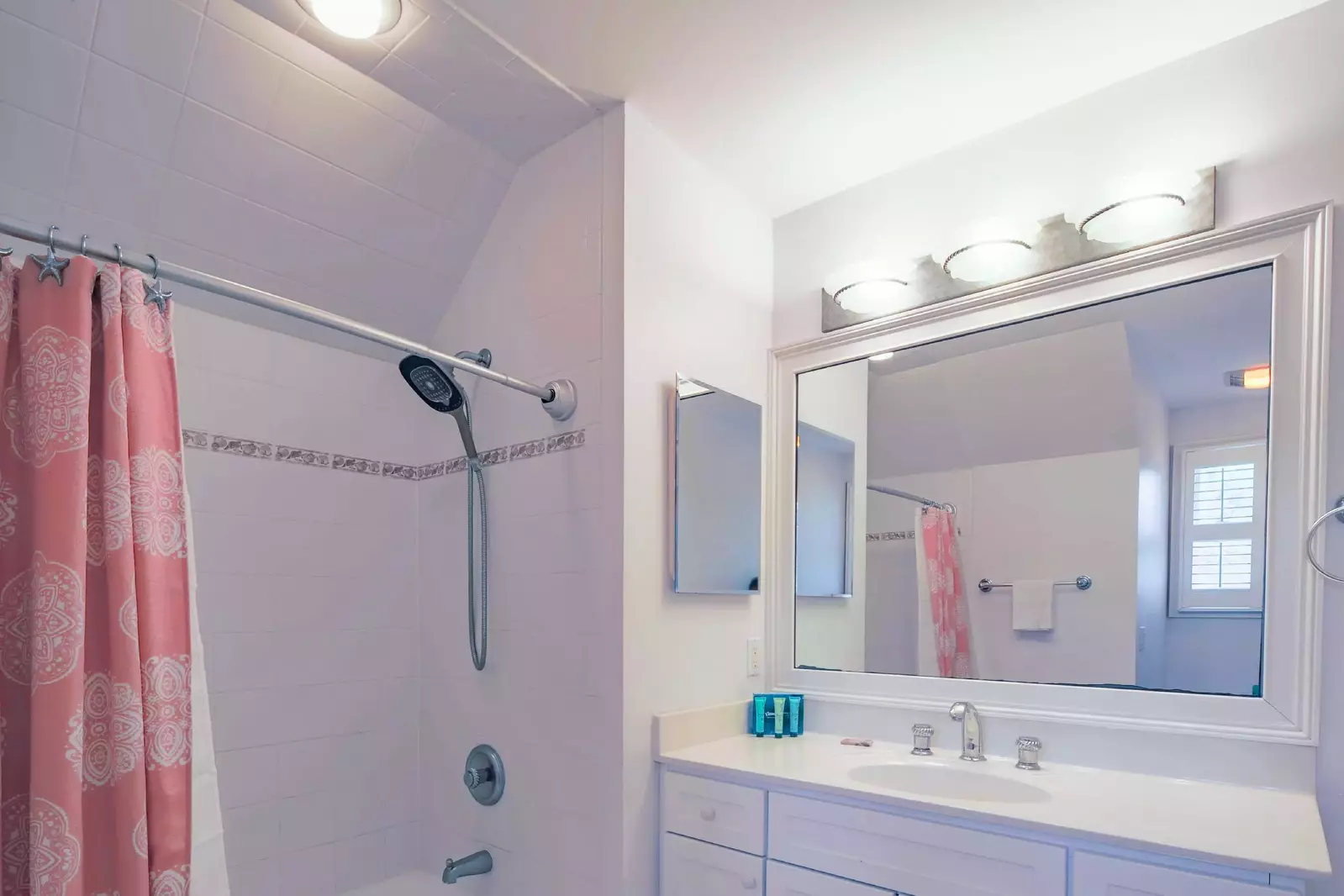 The en suite bathroom features a shower/tub combo and a spacious vanity.