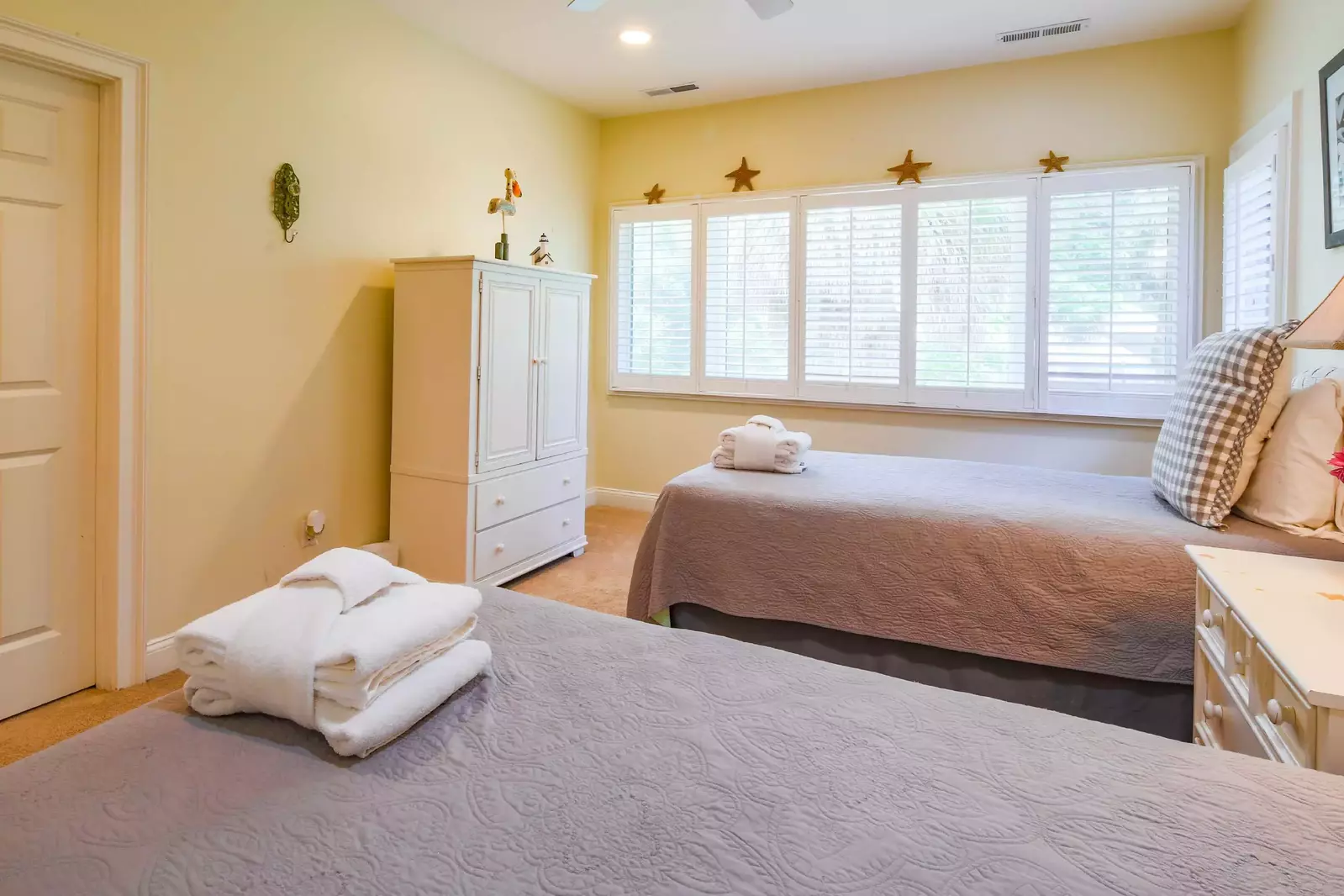 The twin suite also features a ceiling fan and an armoire with TV.