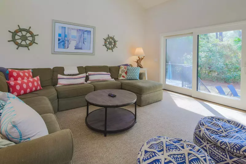 The living room receives lovely natural light through the sliding glass door to the back deck & pool area.
