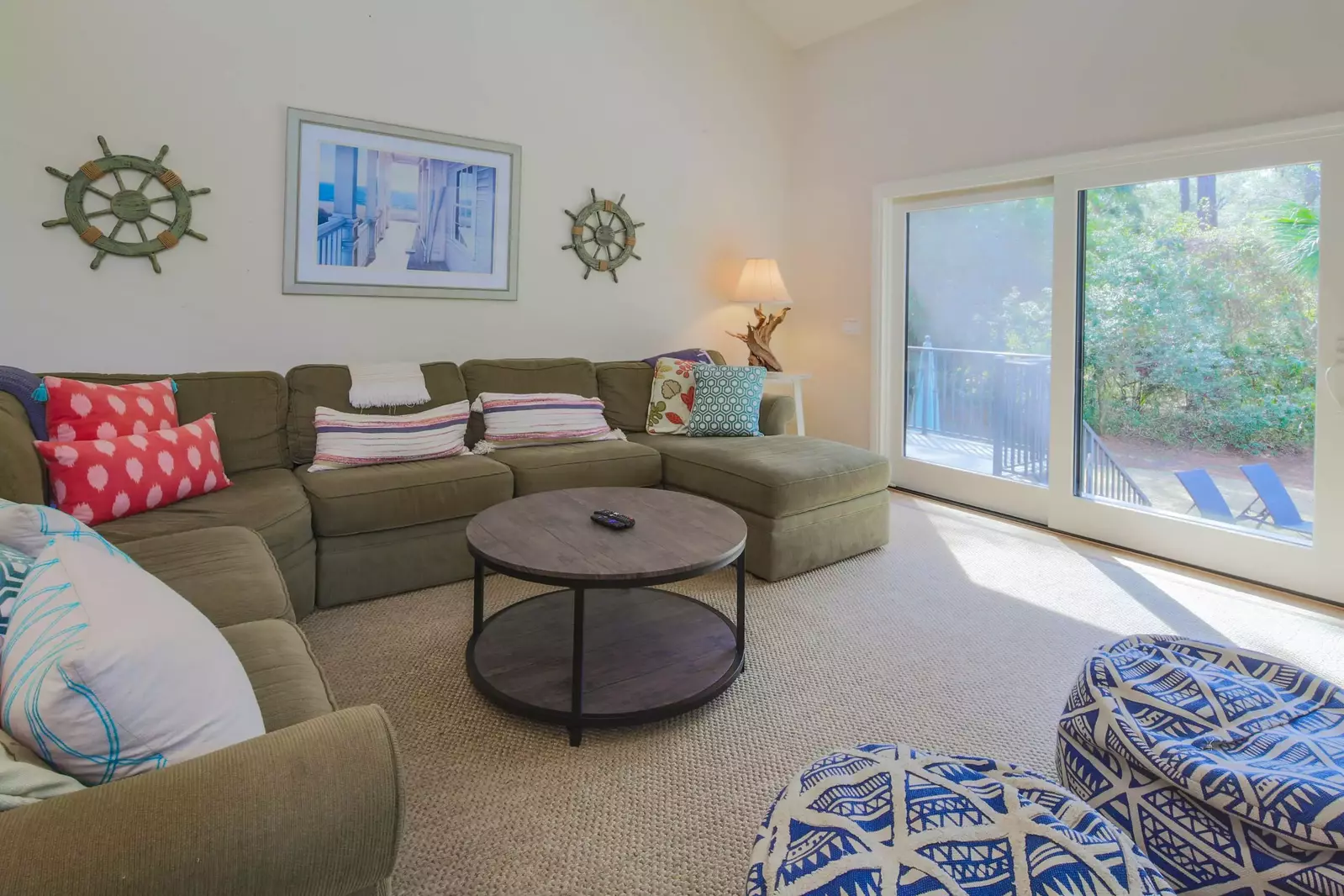 The living room receives lovely natural light through the sliding glass door to the back deck & pool area.