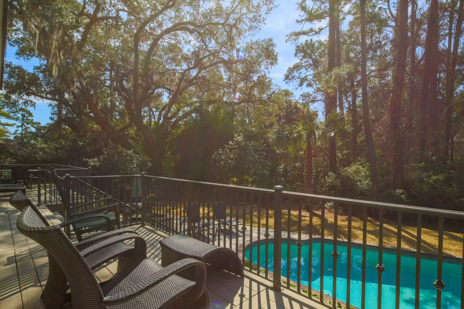 Step out from the living room or the screened porch to access this seating area on the back deck.