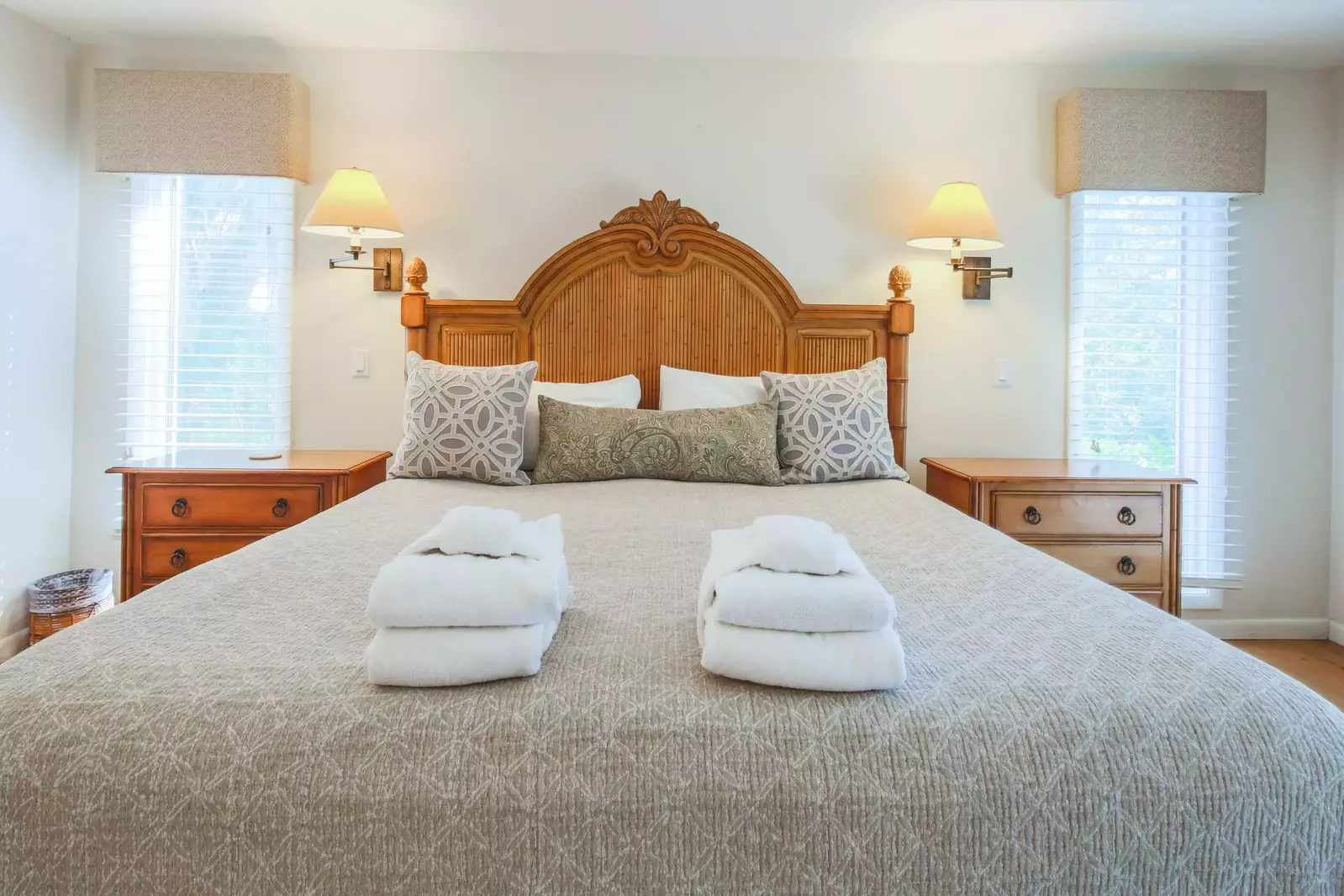 The master suite features a king bed and two night stands with wall sconces.