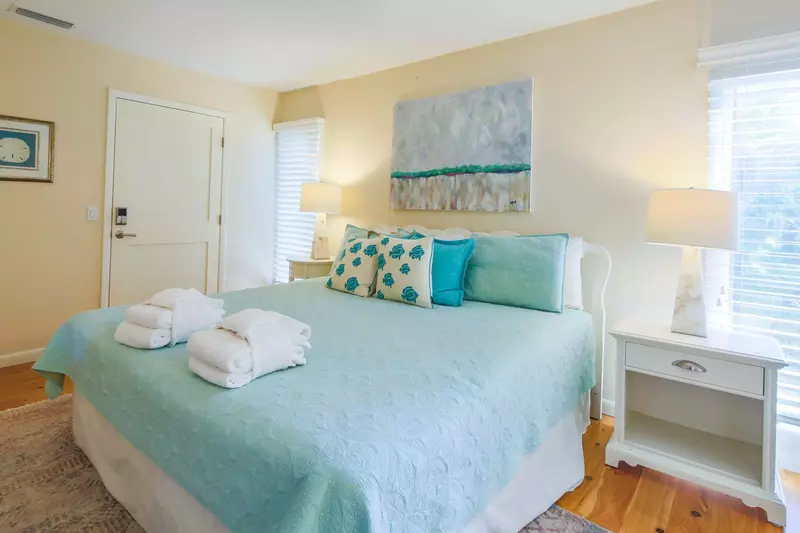 The second master suite features a king bed and night stands with reading lamps.