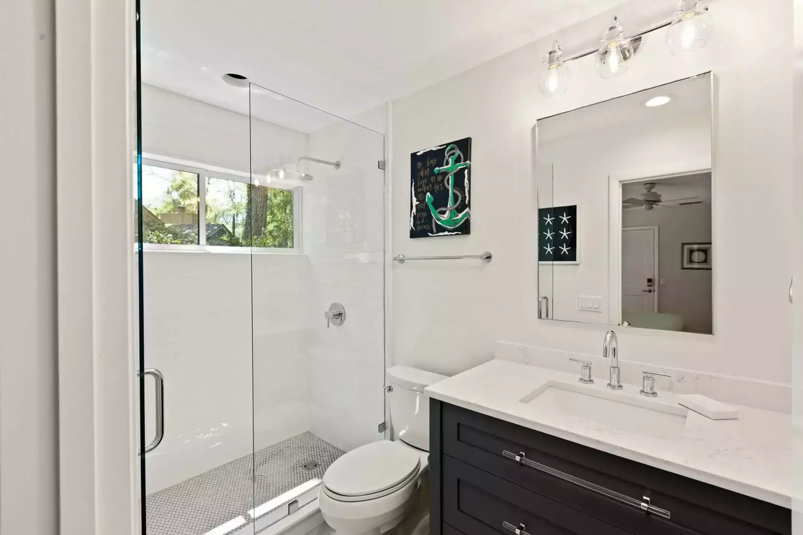 The en suite bathroom features a spacious vanity and a tiled, walk-in shower.